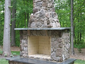 Outdoor fireplace with stone veneer